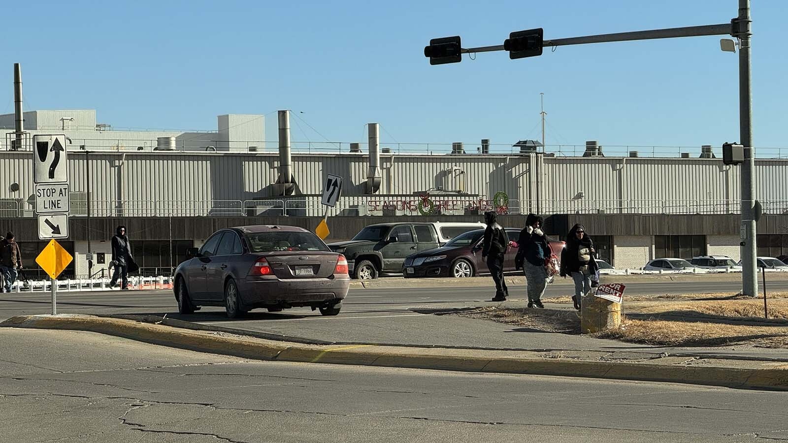 Tyson workers cross Plum Creek Parkway after their shift ends.