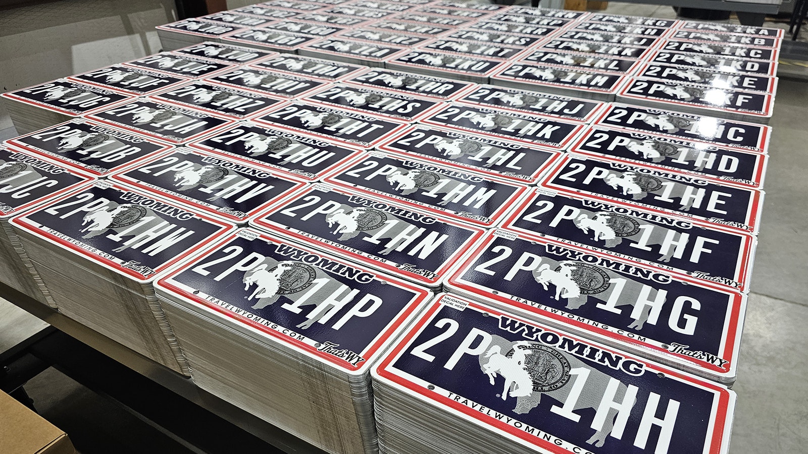 Staffing shortages and equipment failure have created a shortage of Wyoming’s new license plate design. It’s causing counties to scramble, while some Wyomingites, who don’t like the new design (seen in this file photo), are happy for a delay.