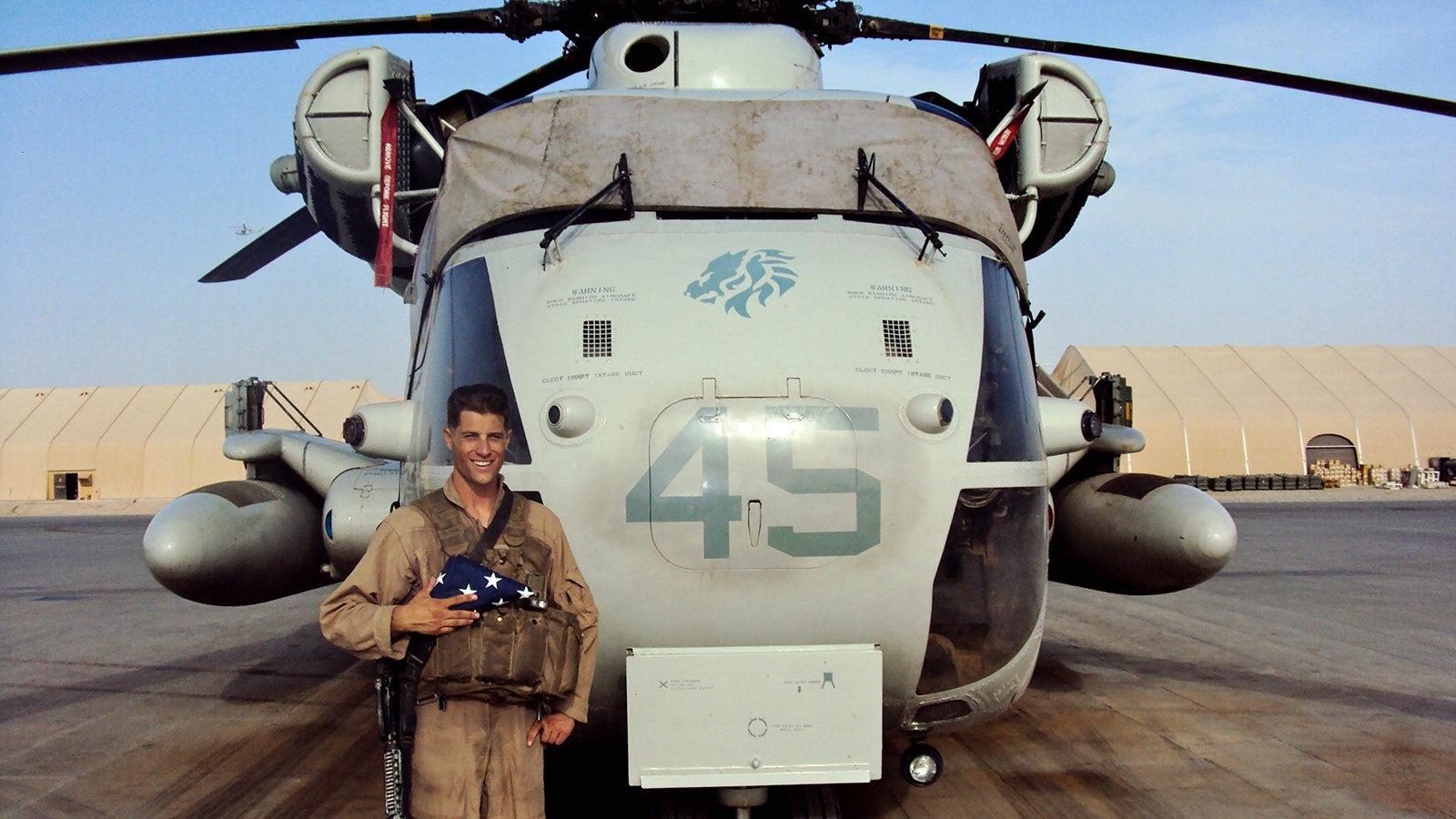 Brandon Busch with the helicopter he flew in Afghanistan as a U.S. Marine.