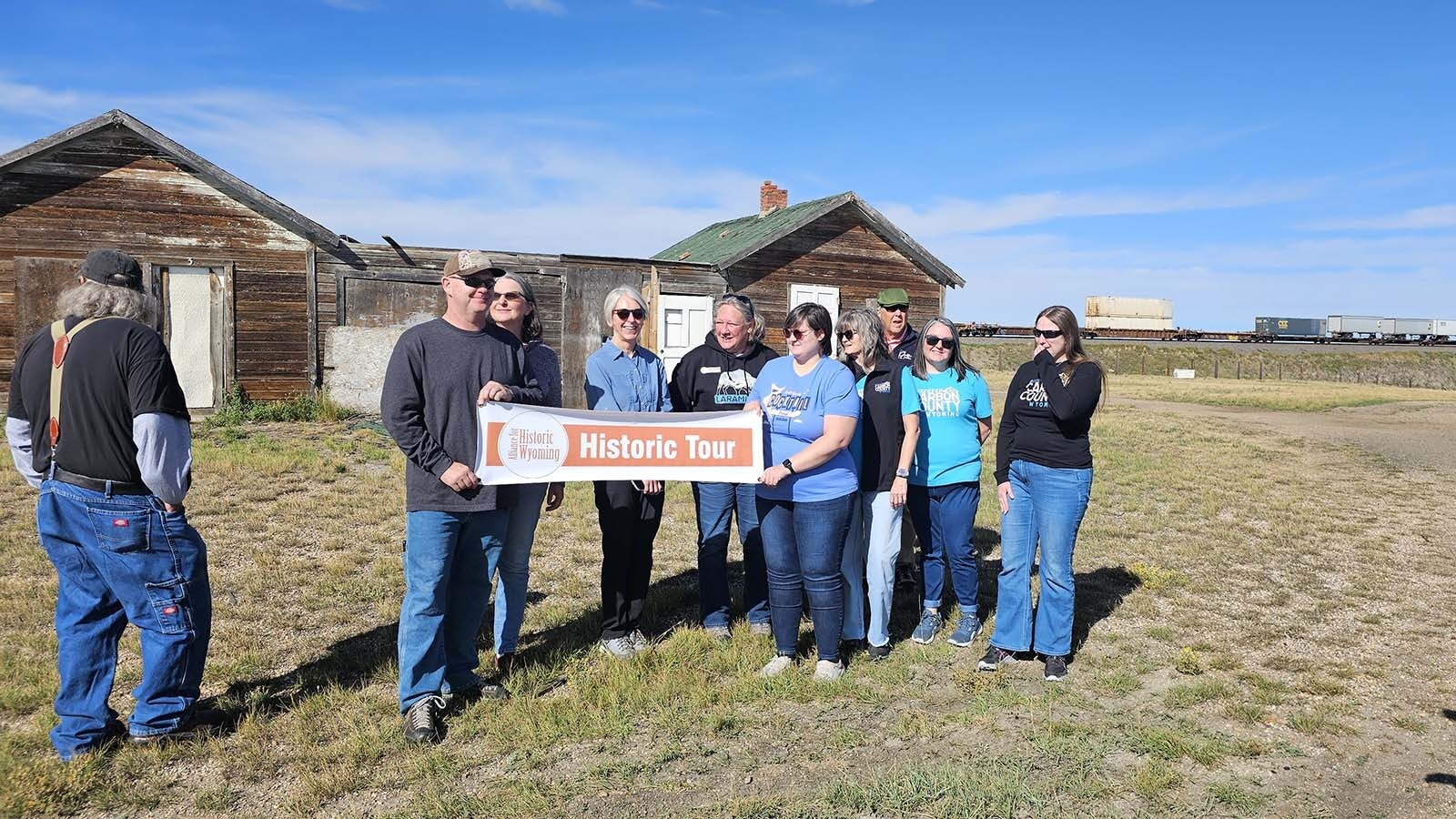 Alliance for Historic Wyoming poses for a photo at the Bosler tourist court during their Lincoln Highway "Unbarred" tour.