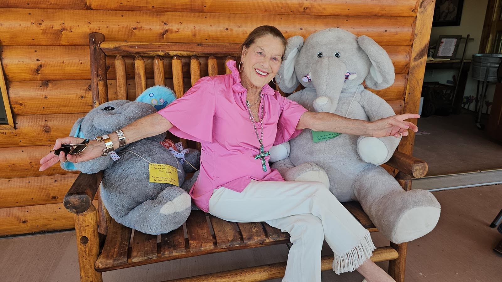 Cheryl Gowdy sits between two stuffed elephants, one named Curtis after her father and the other named Ophelia, representing her mother, Jerre.