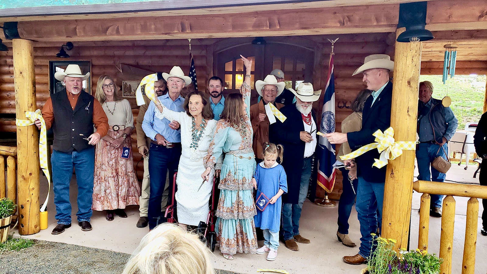 Jerre and Cheryl Gowdy, center, cut the ribbon on the new Little House on the Park at Curt Gowdy State Park on Saturday.