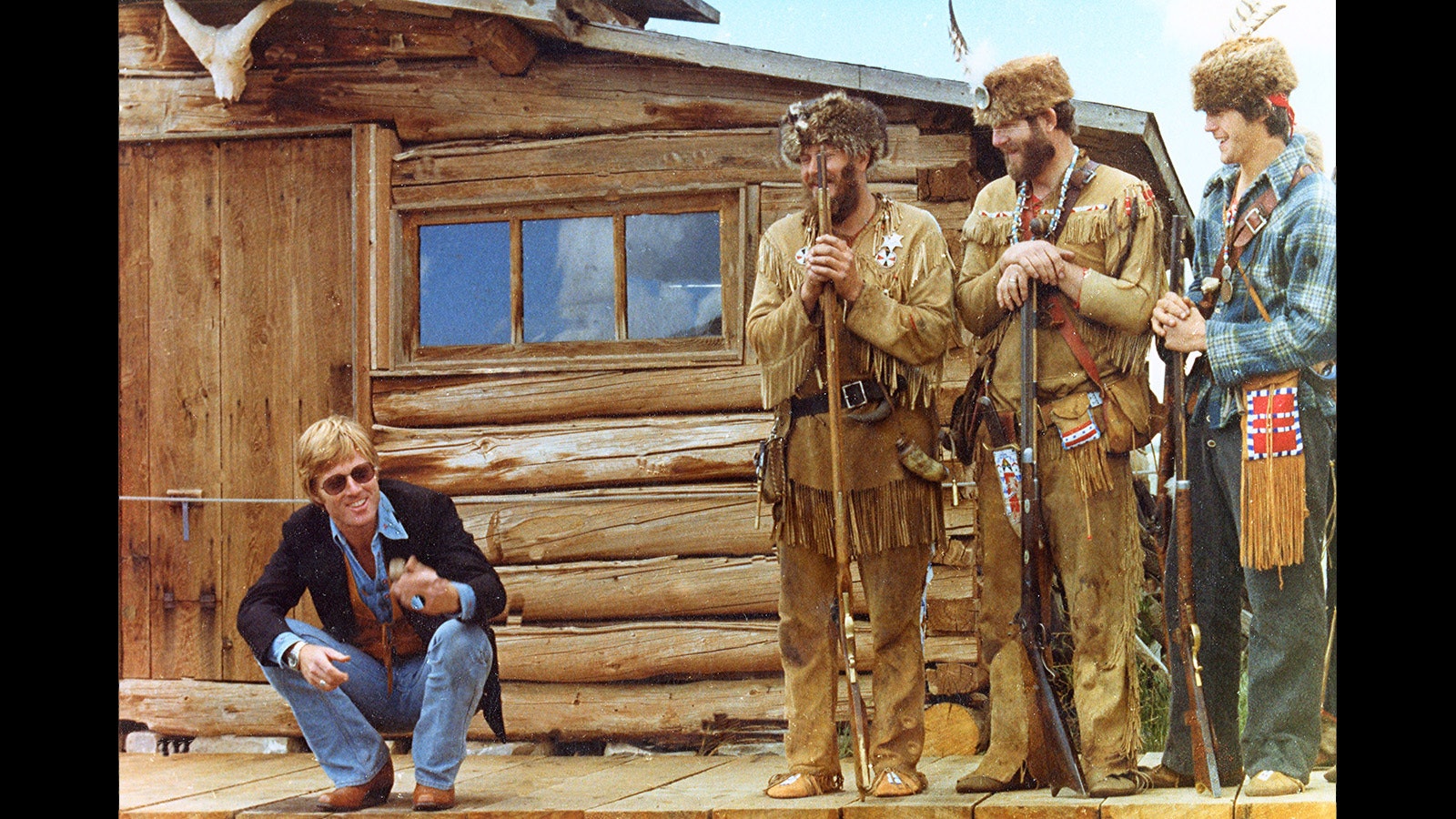 Robert Redford shares a laugh with a group of mountain men at the reburial of Liver-Eating Johnson in Cody's Old Trail Town.