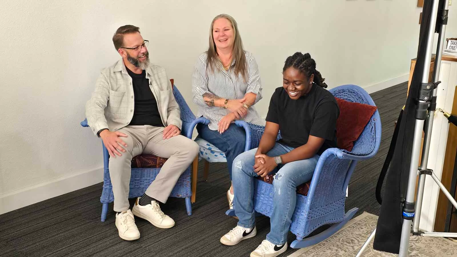 Savannah Levett, right, laughs as her adopted family tells how she made them do a pre-Thanksgiving interview before she would agree to join them.