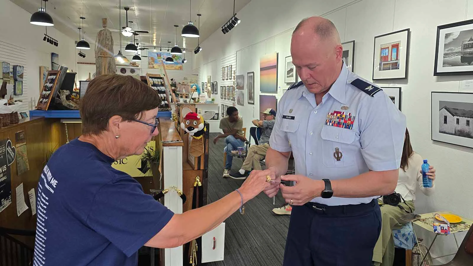 Lucy Rose hands Col. Terrance “Terry” Holmes, wing commander of the 90th Missile Wing at F.E. Warren Air Force Base a QR code for her National Day of Connection on Nov. 12. She’s asking Americans to pause for 12 minutes and connect with someone they haven’t talked to in a while on that day.