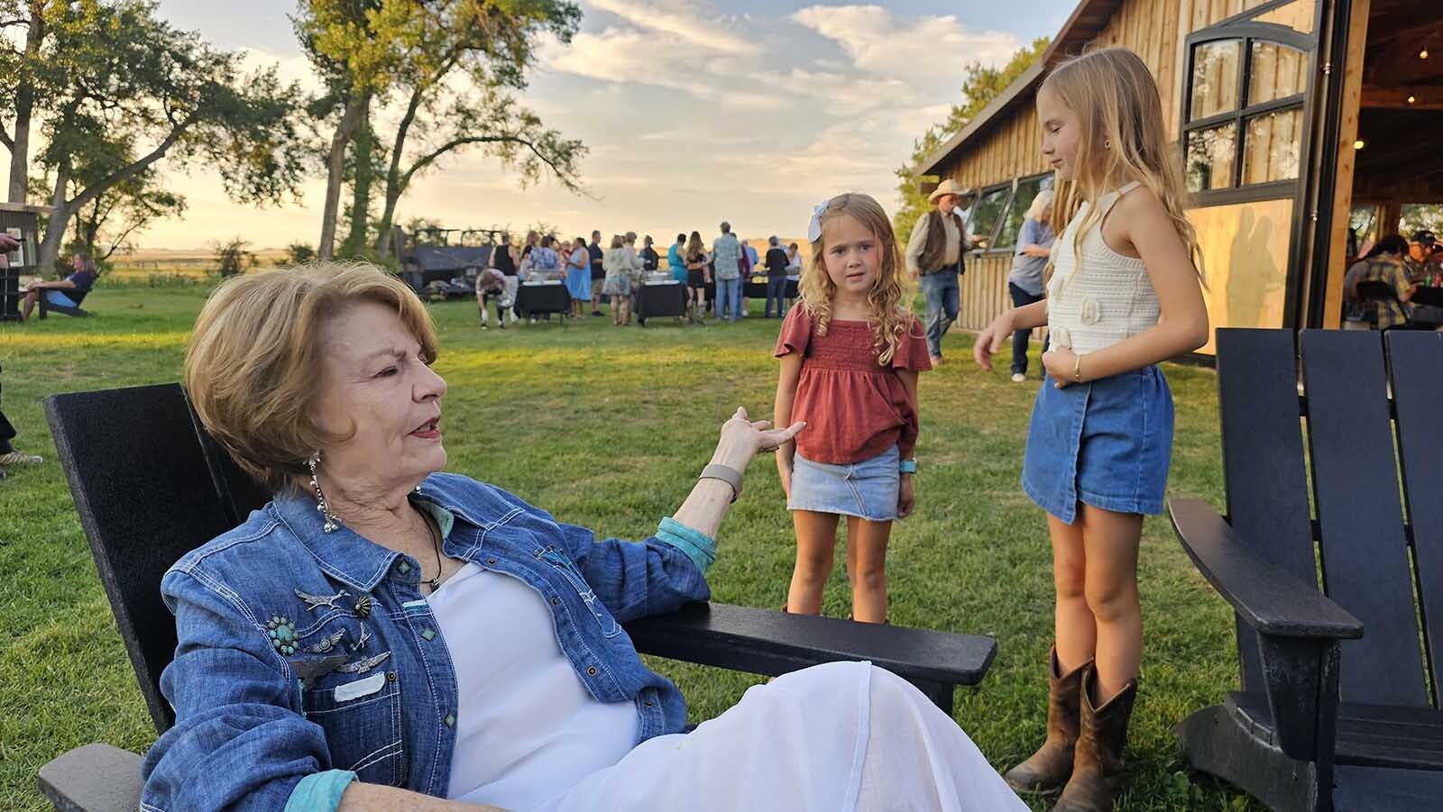 Louanne Stephens chats with a couple of young cowgirls, and asks them if they plan to participate in her talent show next year.