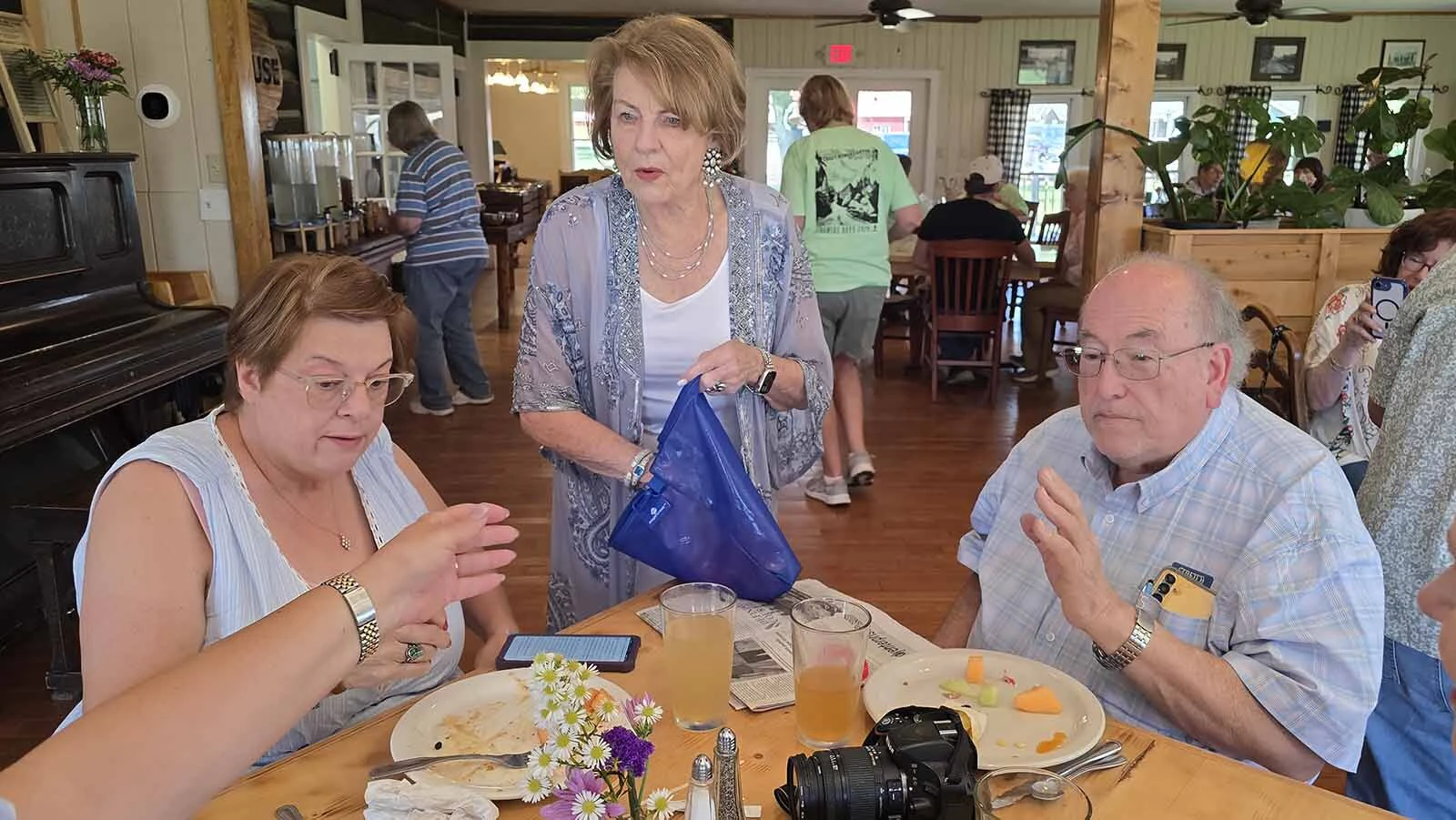 Louanne Stephens, who played Ruby in the hit television series, "Longmire," passes out bracelets to guests of her brunch during Longmire Days in Buffalo.