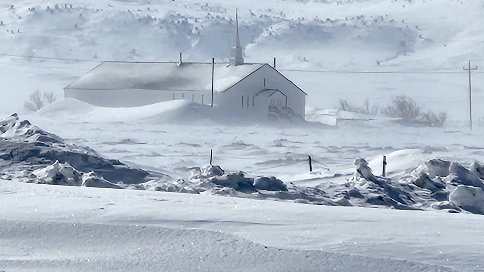 A church in Jeffrey City, Wyoming is half buried in snow this past winter along Tebra Morris' rural mail route.