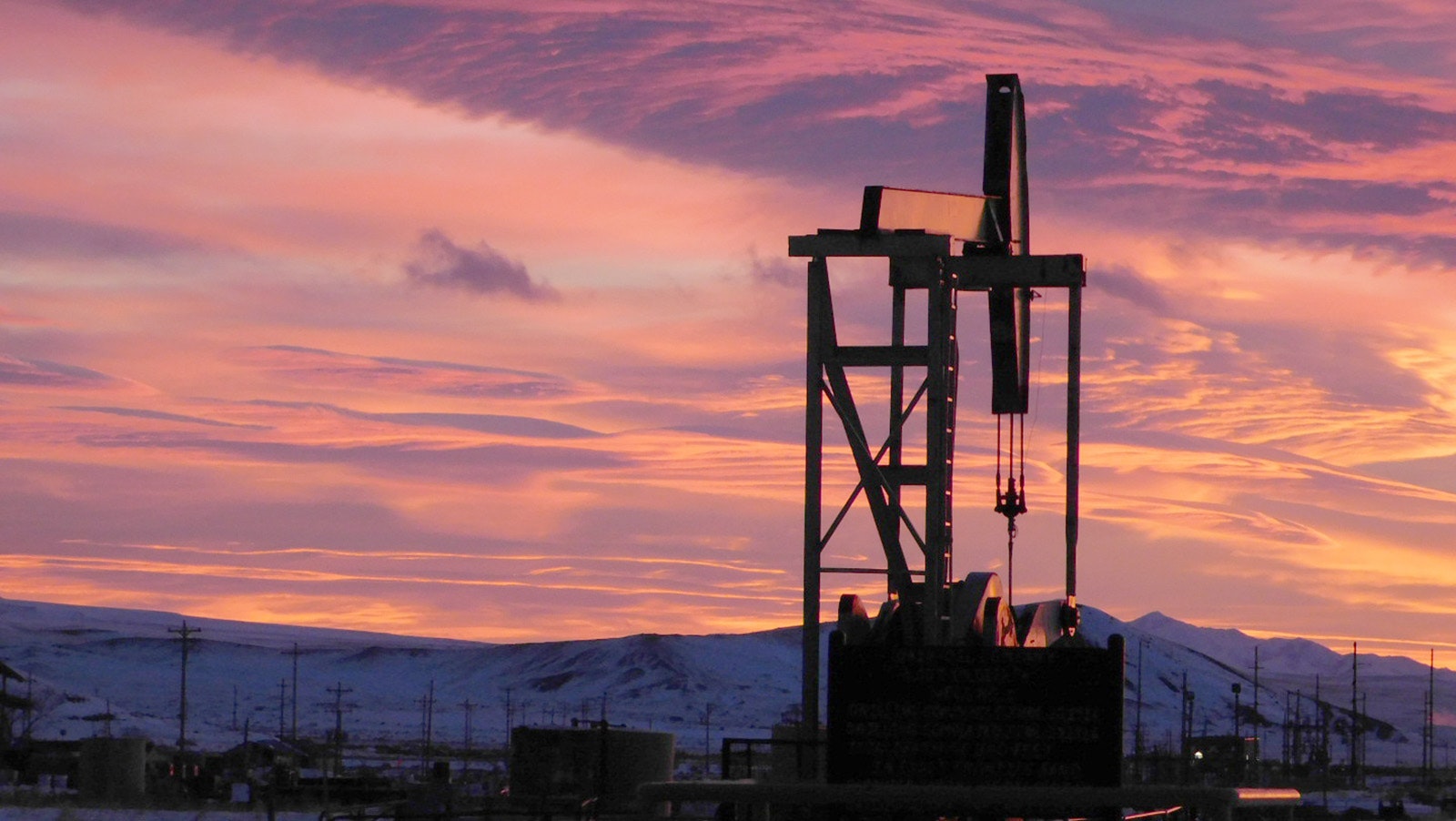 The sunrise silhouettes this pumpjack in rural Wyoming along Tebra Morris' mail route.