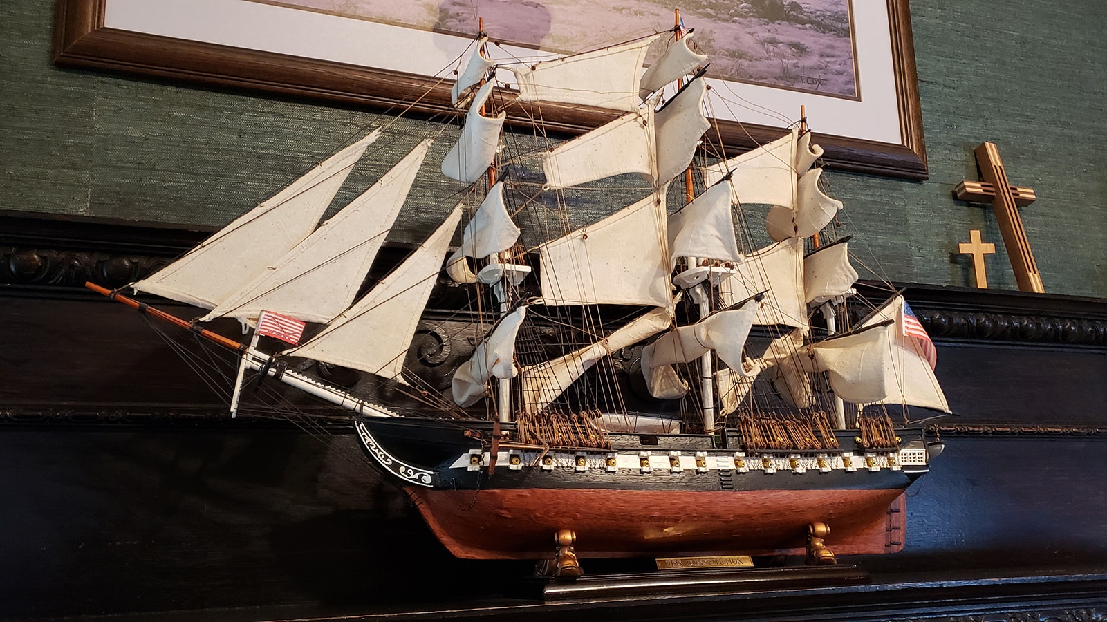 Zane Fross found this old Ironsides replica and bought it to display on a mantle of one of the many fireplaces in the J.B. Okie Mansion, because the house "just begs for art."
