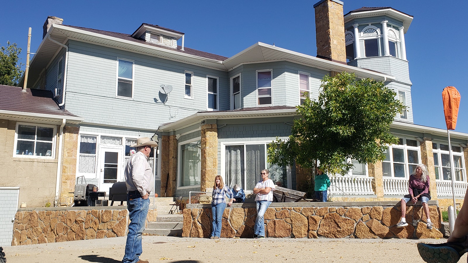 Zane Fross, left, talks about the J.B. Okie mansion to a recent tour group.