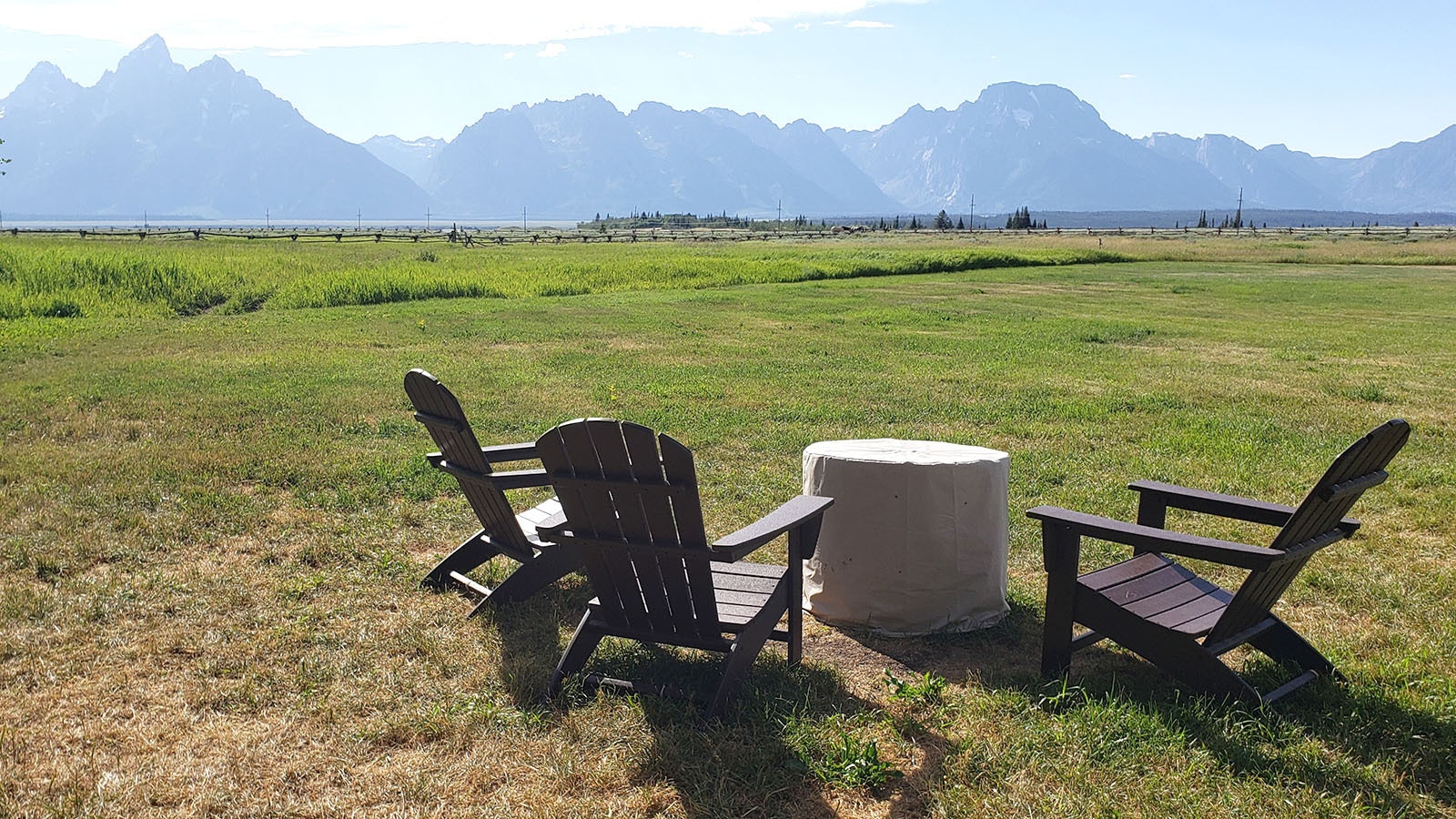 These chairs sit at a square of manicured lawn that's often used for weddings. They're an ideal spot to take in a Teton sunset .