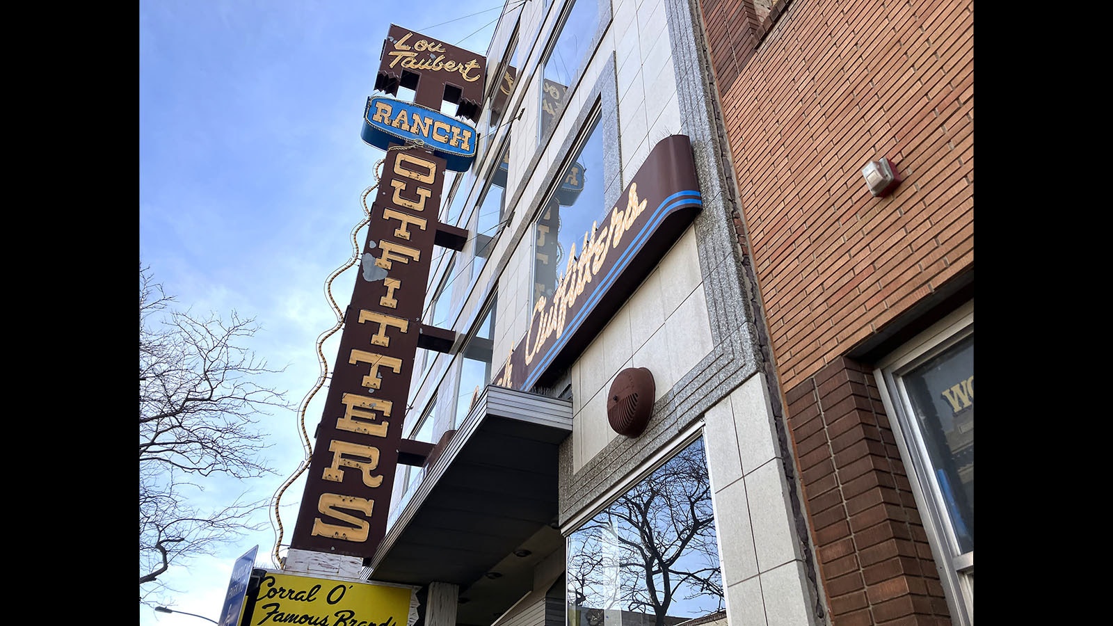 A classic neon sign advertises Lou Taubert Ranch Outfitters outside its four-story building in downtown Casper.
