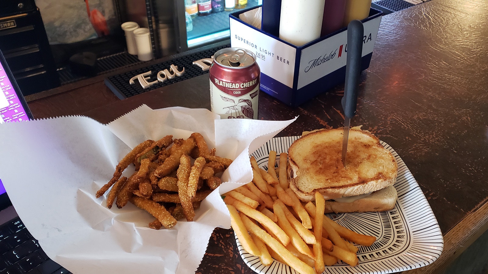 4 Corners Bar serves up jalapenñ popper cheese sandwich with fried pickles and a Flathead Cherry Cider