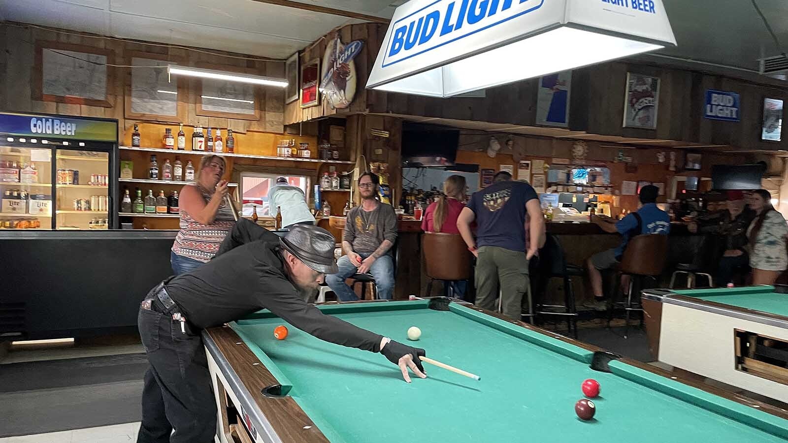 Anthony Gatherers shoots some pool at the Lucky 5 Lounge in Shoshoni, Wyoming.