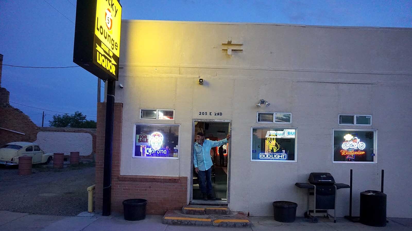 Bartender Steve Mullen catches some fresh air in the doorway of the Lucky 5 Lounge in Shoshoni, Wyoming.