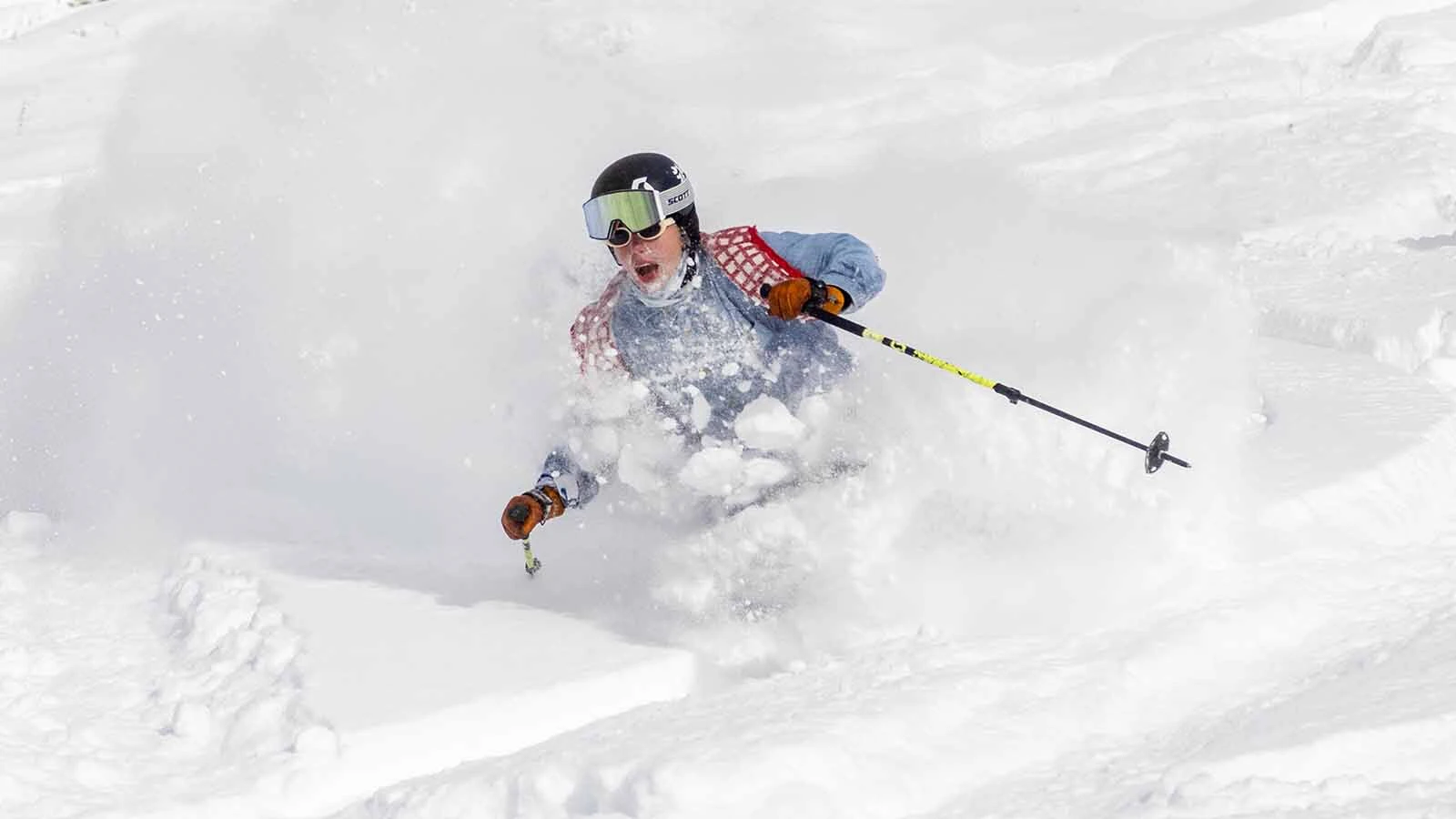 A skier gets a facefull of powder during a run at Jackson Hole Mountain Resort in this file photo.