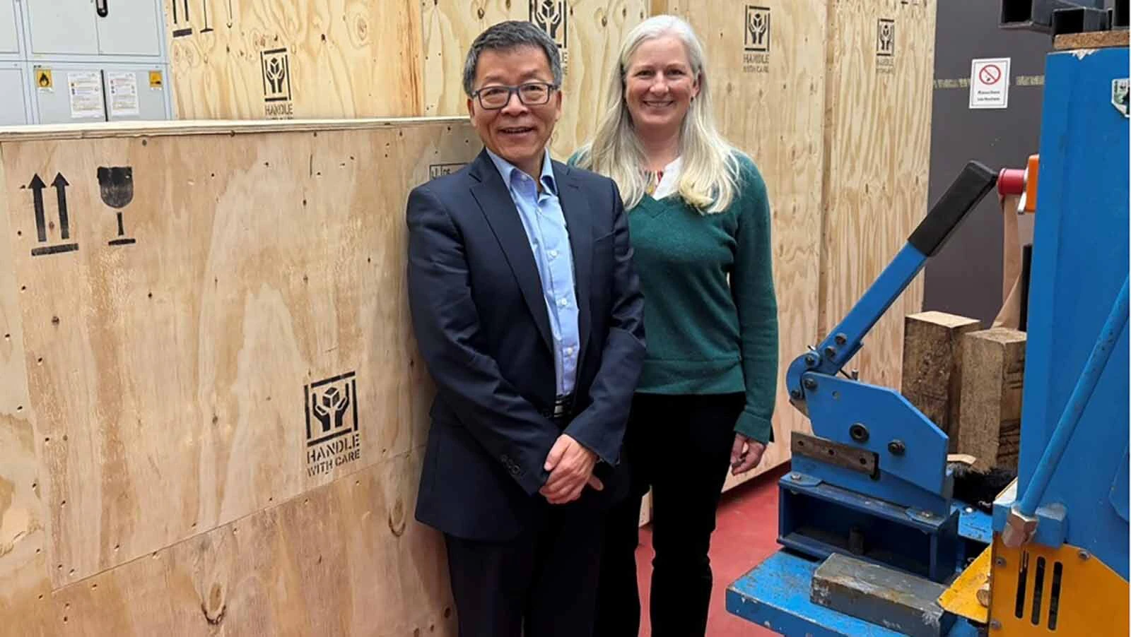 University of Wyoming Science Institute Professor Jinke Tang with UW Vice Provost for Global Engagement Professor Isadora Helfgott in front of the boxed up super magnet just before shipping.