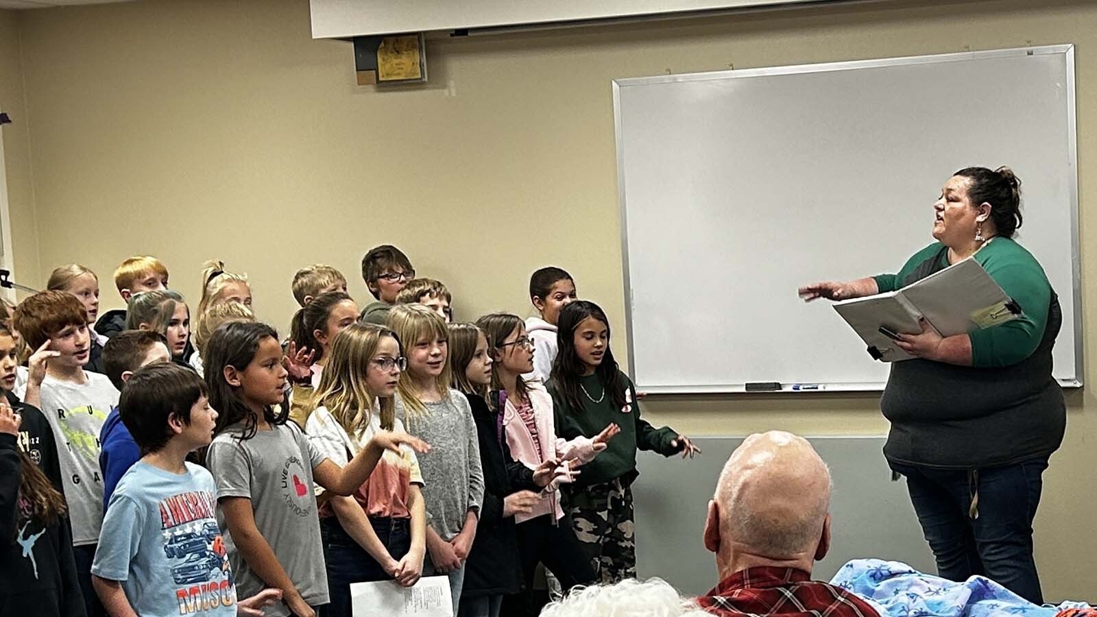 Mandie Asay leads students in song at a care facility in Powell, Wyoming.