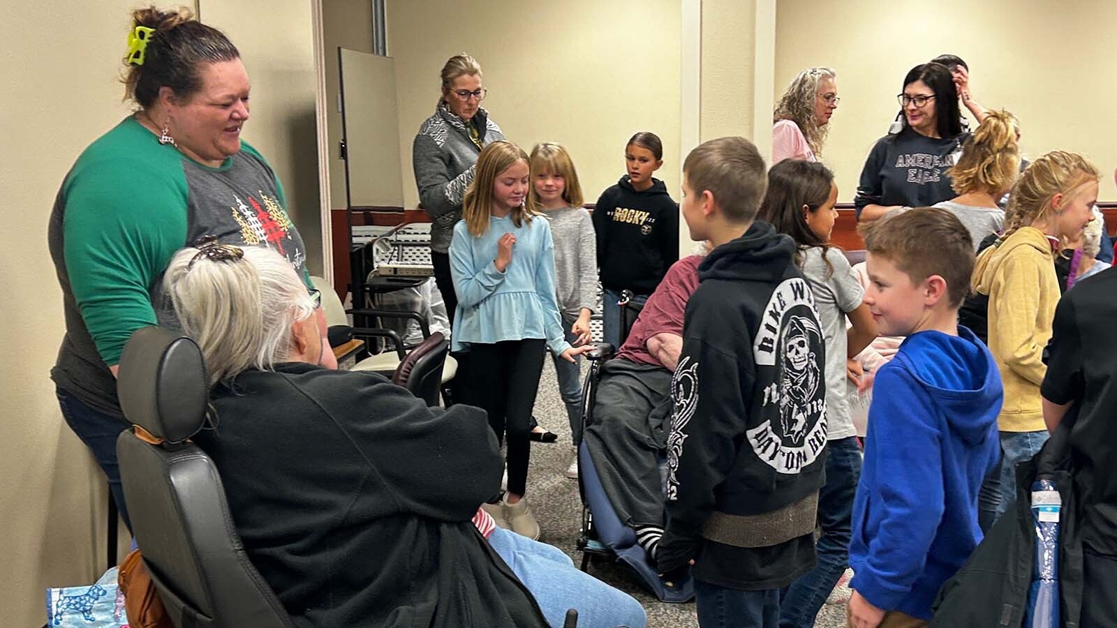 Mandie Asay and elementary students during a visit to a local care facility.