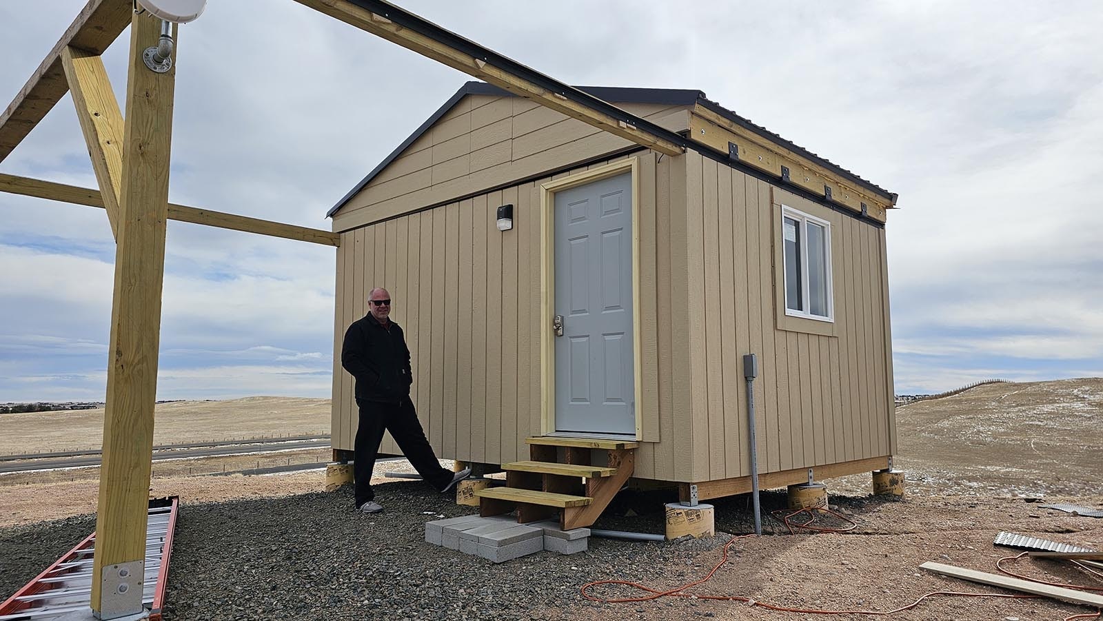 Marty Curran outside the observatory he built just outside of Cheyenne. It looks like a shed, but the roof lifts off at the touch of a button and the south wall drops down for telescopes inside.