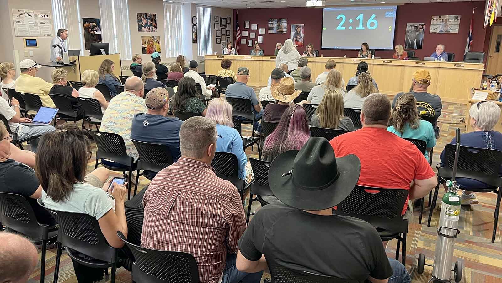 The Laramie County School District 1 board members listen and people speak during Friday's meeting.