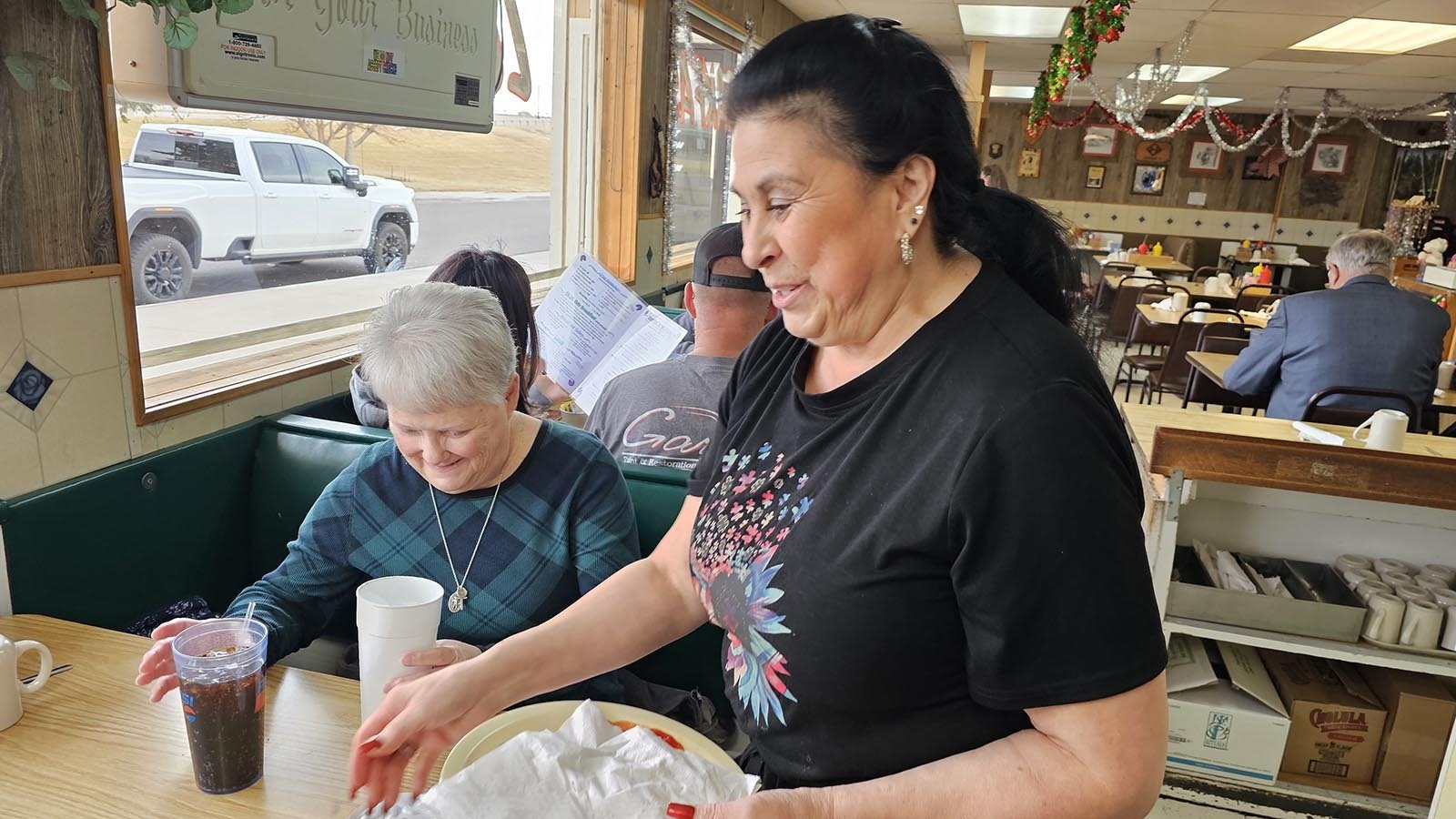 Margaret Lovato clears tables at Diamond Horseshoe Cafe in Cheyenne, where she has worked for almost 50 years.