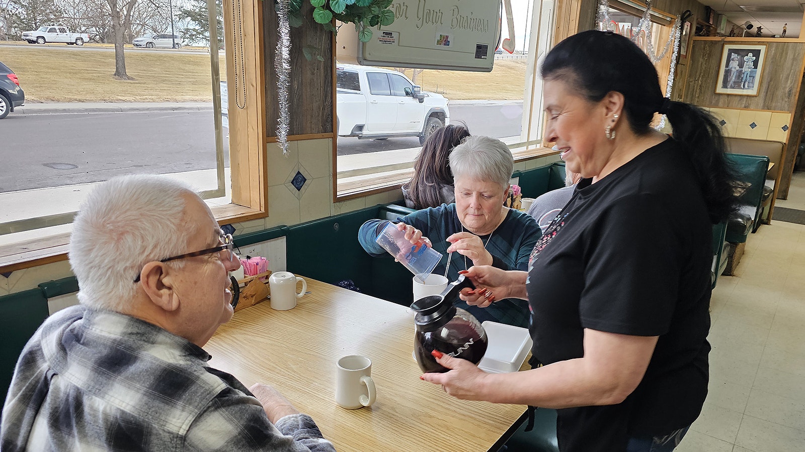 Margaret Lovato pours a refill of coffee with a smile at Diamond Horseshoe Cafe in Cheyenne, where she has worked for almost 50 years.