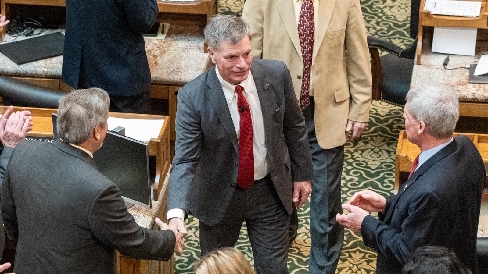 Gov. Mark Gordon greets members of the Wyoming Legislature before their 2024 session convened.