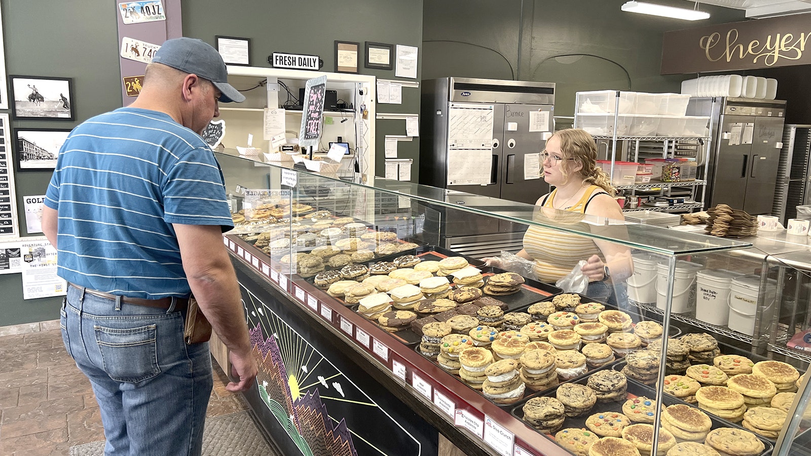 Morgan Sutherland, right, fills an order for Jeremy Dogged at Mary's Mountain Cookies in downtown Cheyenne on Monday. Sutherland said police and other emergency responders are welcome in the cookie shop.