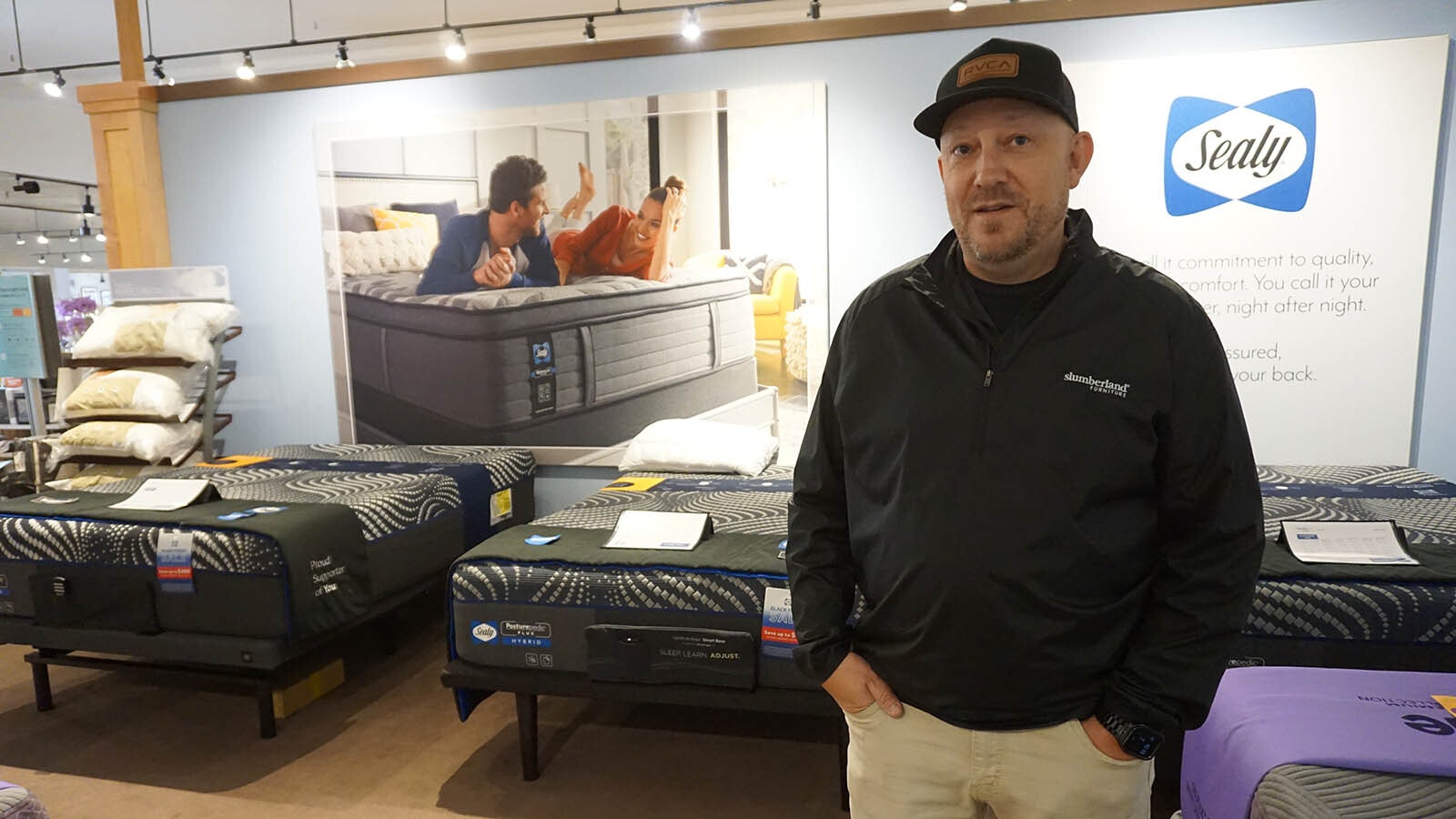 Tony Hager poses on sales floor of Slumberland Casper. He and a small army of volunteers delivered 40 new beds to deserving children on Saturday.