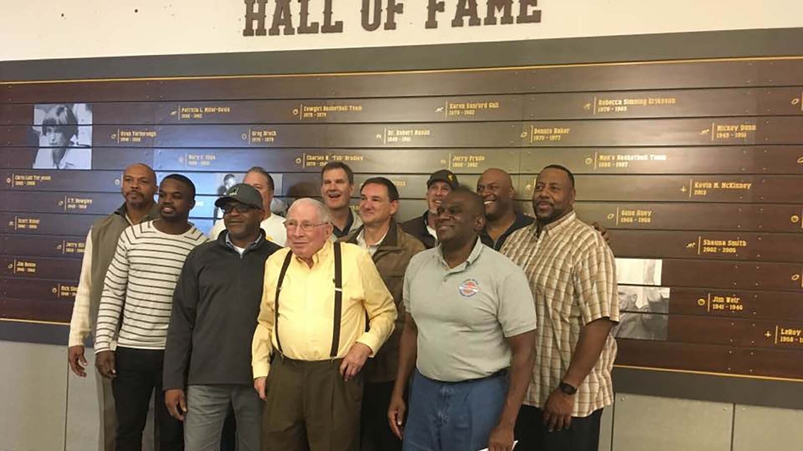 Maury Brown with a group of former UW basketball players in 2017 during a dedication ceremony for the Kenny Sailors statue.