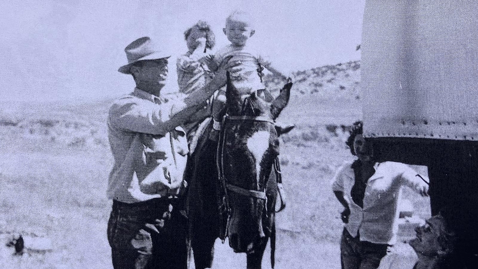 Tim McKinney is placed on a horse by his dad.