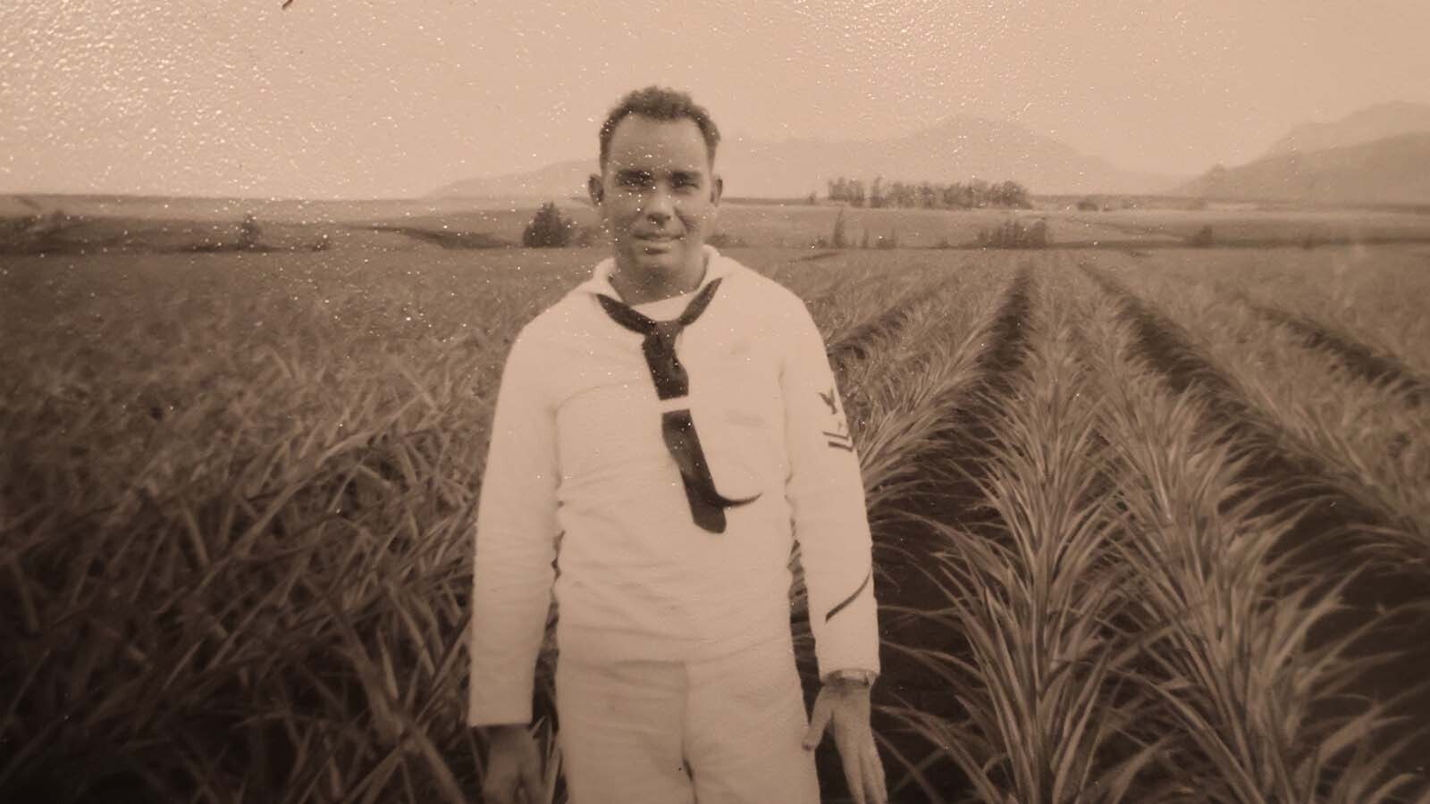 Bill McMillan poses in a field while on a deployment.