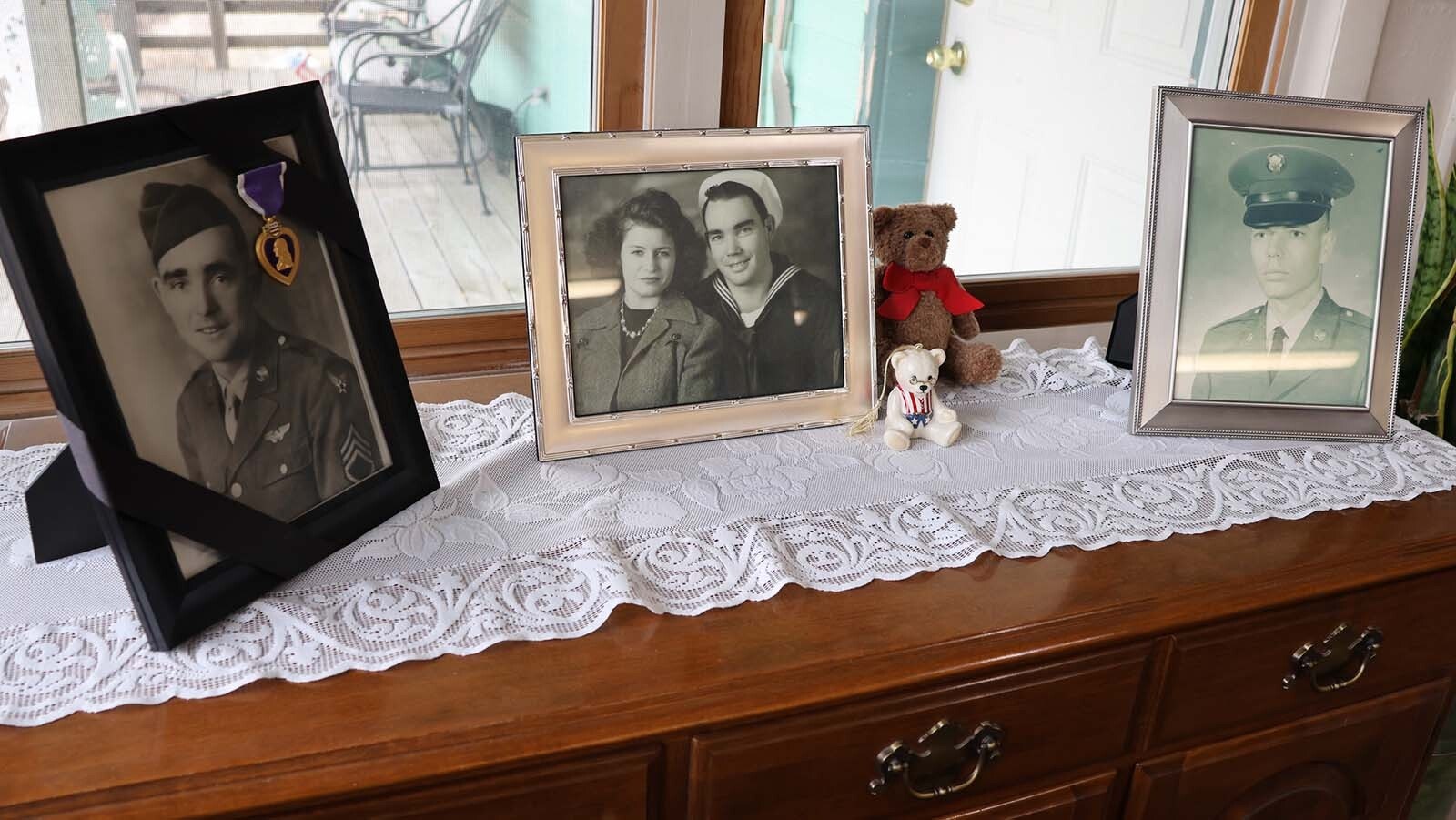 Photos in the dining area of the McMillan home show the two-generations of military service. At left is a photo of Walter F. McMillan Jr., a gunner on a bomber who lost his life in World War II. In the middle is a photo of Bill McMillan and his wife, Lucy Helen, and Walter McMillan, Bill’s son who served stateside in the U.S. Army during the Vietnam War.
