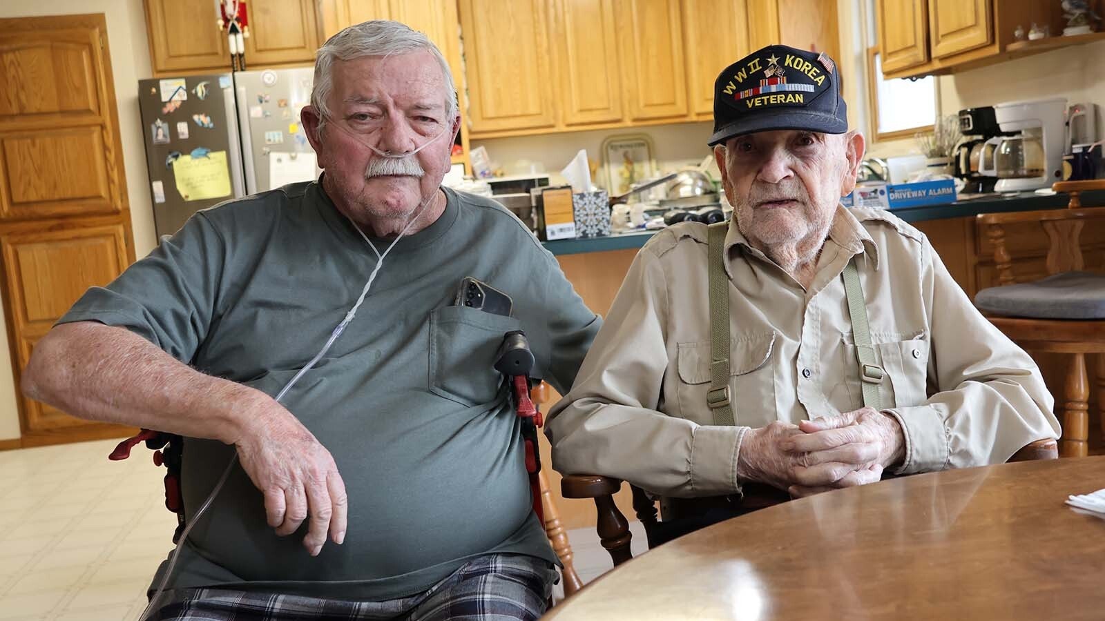 Walter, left, and Bill McMillan, son and father, keep an eye out for each other in their home west of Casper.