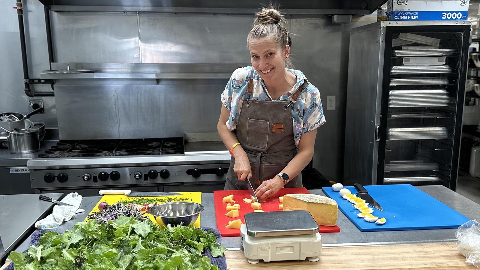 Hannah Darrin works in the industrial kitchen at Meadowlark Market and Kitchen preparing salads.