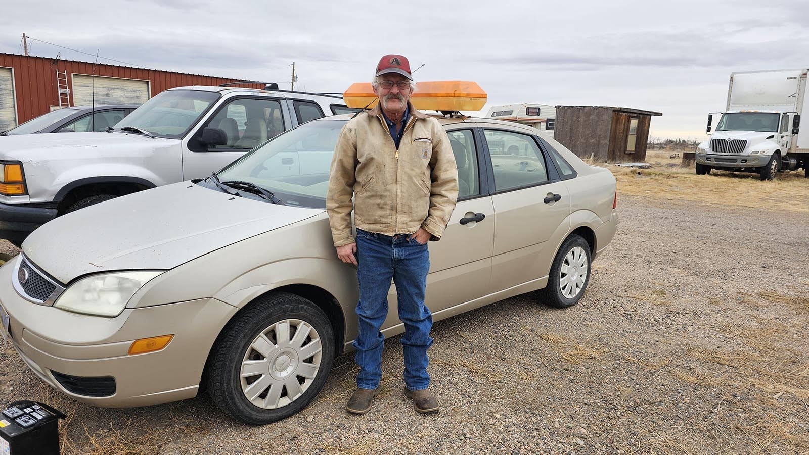 John Haggerty in front of the car he used as a medical courier, even when I-80 was closed.