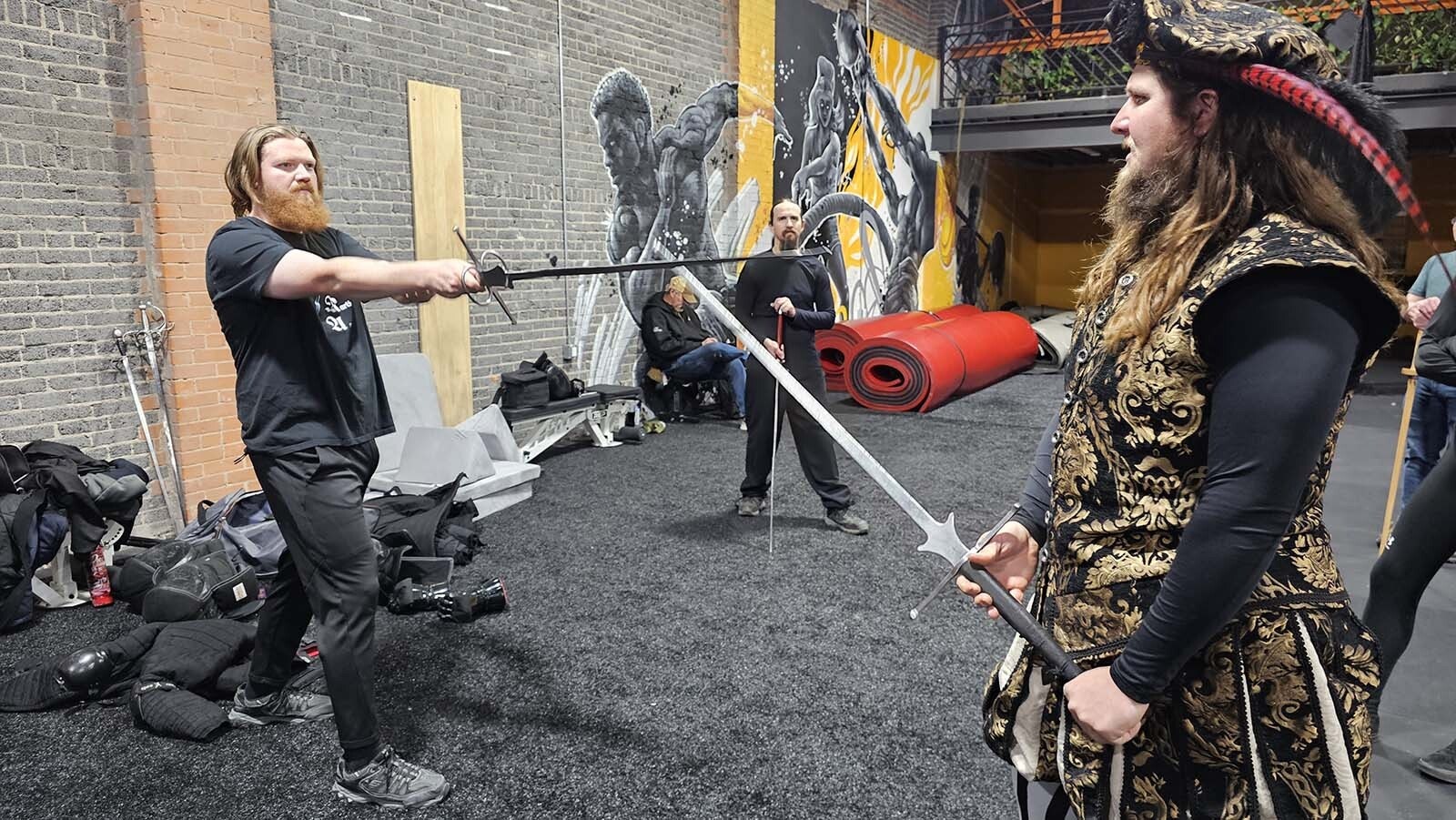 Greg Tucker, left, and Michael Binsse demonstrate a couple of medieval sword maneuvers during a Historical European Martial Arts in Cheyenne.