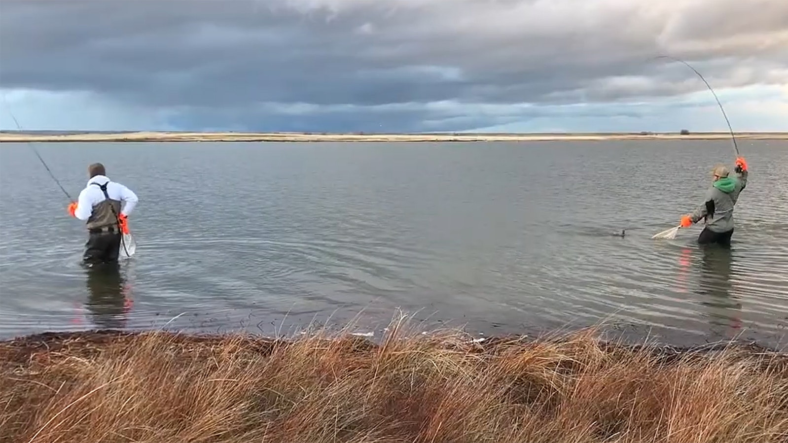 A pair of fly fishermen try their luck at Meeboer Lake near Laramie, Wyoming. This past winter, all the trout in the lake died.
