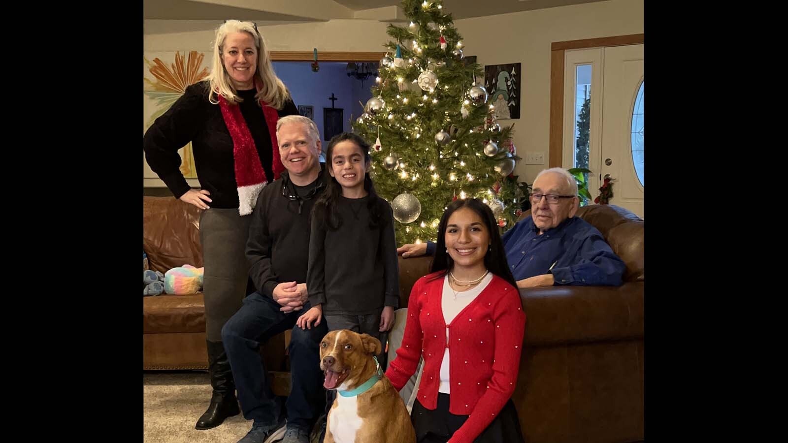 Melissa Watson, far left, with her family, including her father, who she's become the main caregiver for.