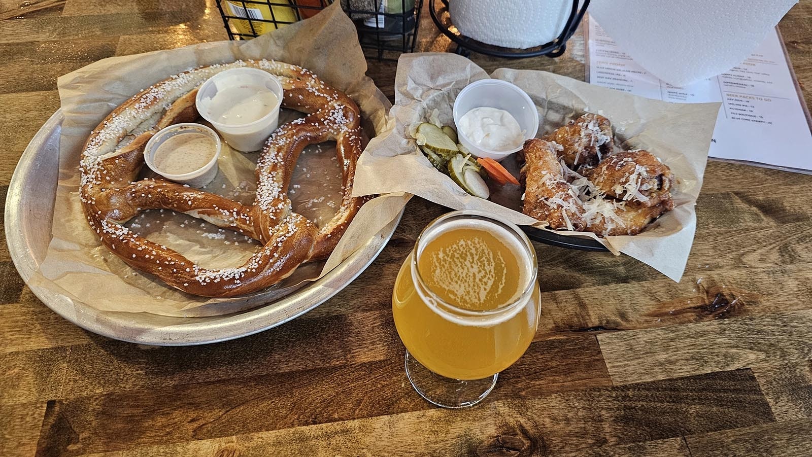 Beers come with a tasty selection of bar food, like pretzels with beer cheese dip and hot wings.