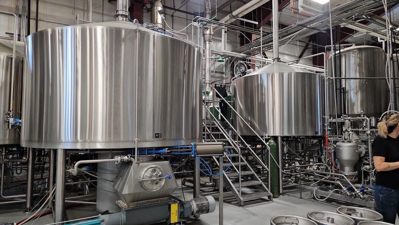 This is the brew deck, which is where the beer manufacturing process starts. Grain is dropped from above into vats to be washed and mashed and cooked.