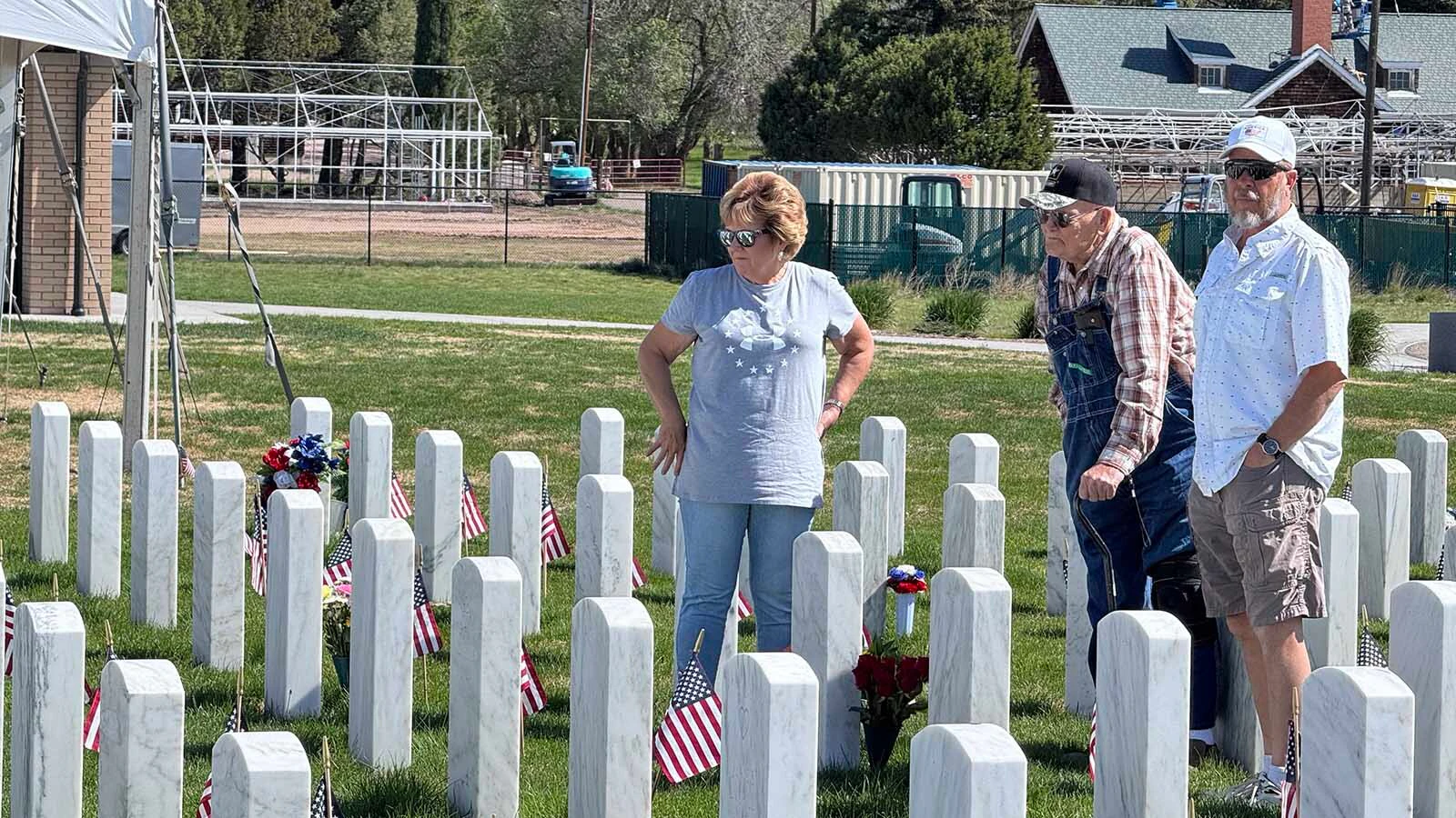 James, center, and Kevin Read visit the grave where James will one day be buried at the Cheyenne National Cemetery on Monday, and where James' wife is already waiting for him.