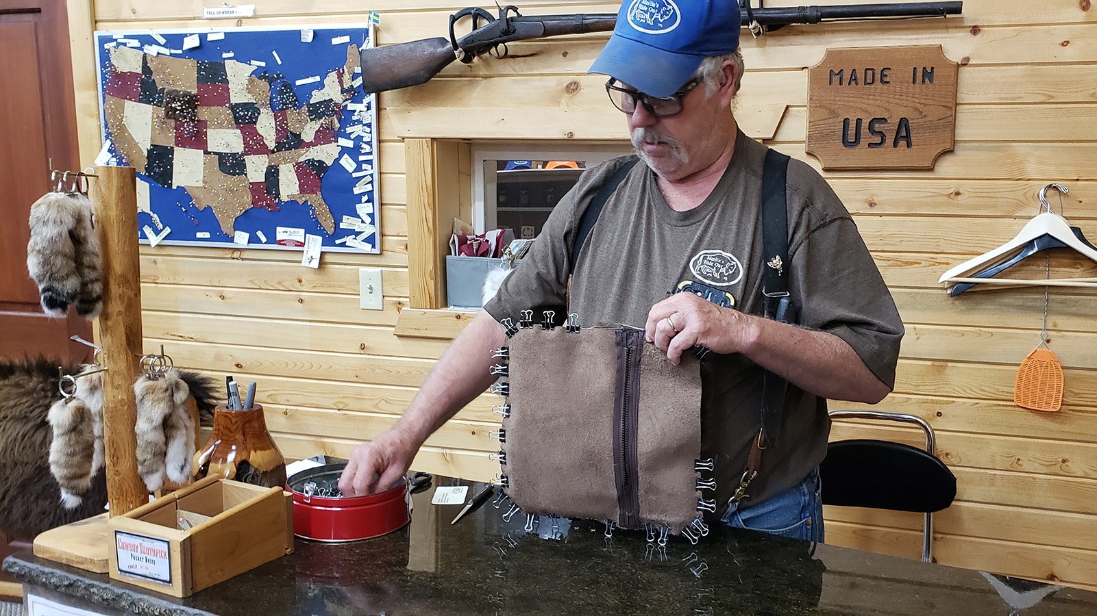 Merlin Heinze just likes to make things. While he's in the store with nothing else to do, he works on making a few more buffalo fur pillows.