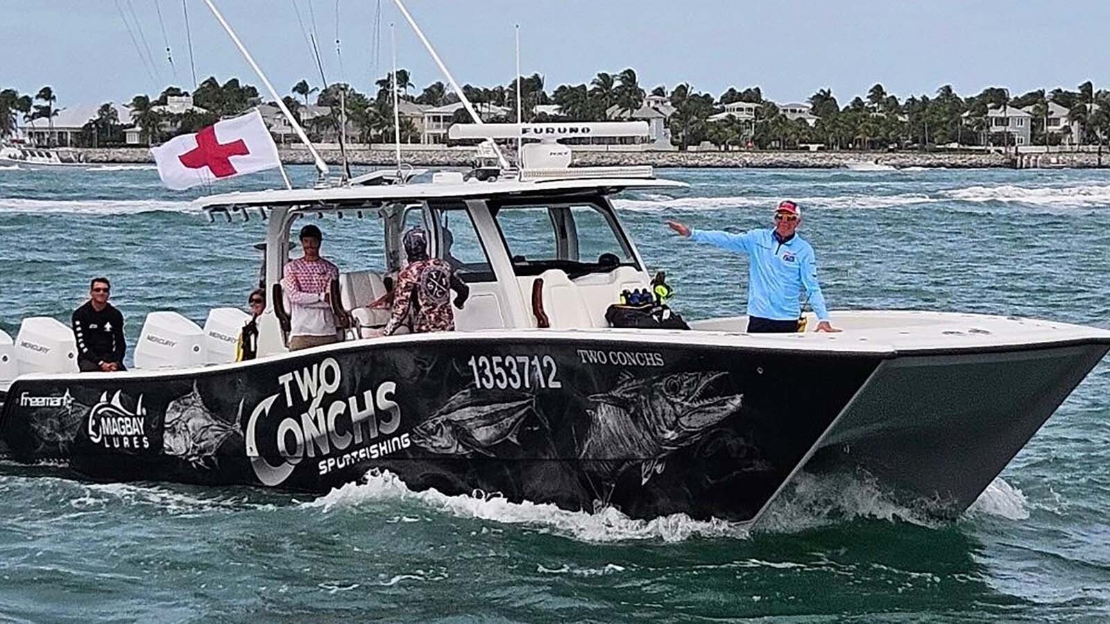 Michael Janssen stands ready to respond in the bow of a rescue ship.