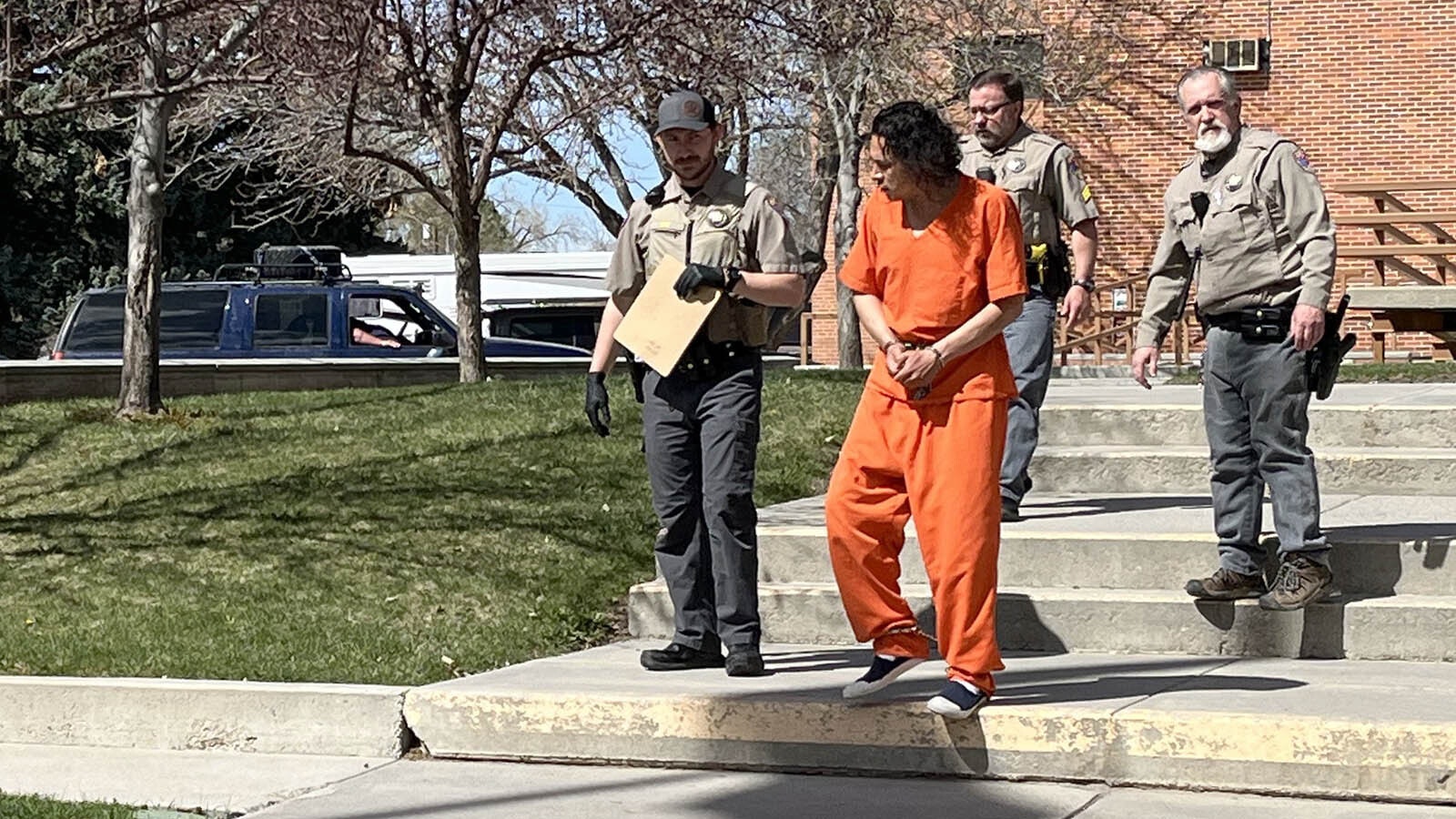 Deputies escort a shackled Michael Vigil to a jail transport vehicle after Vigil’s initial appearance in Lander Circuit Court on Tuesday afternoon.