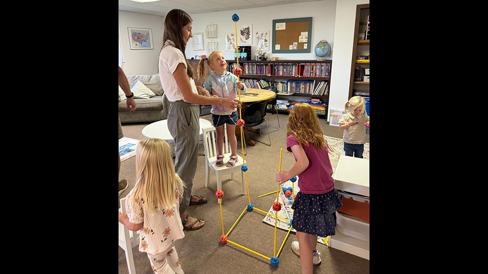 Homestead Learning teacher, Erin Beck, leads students in a science experiment.