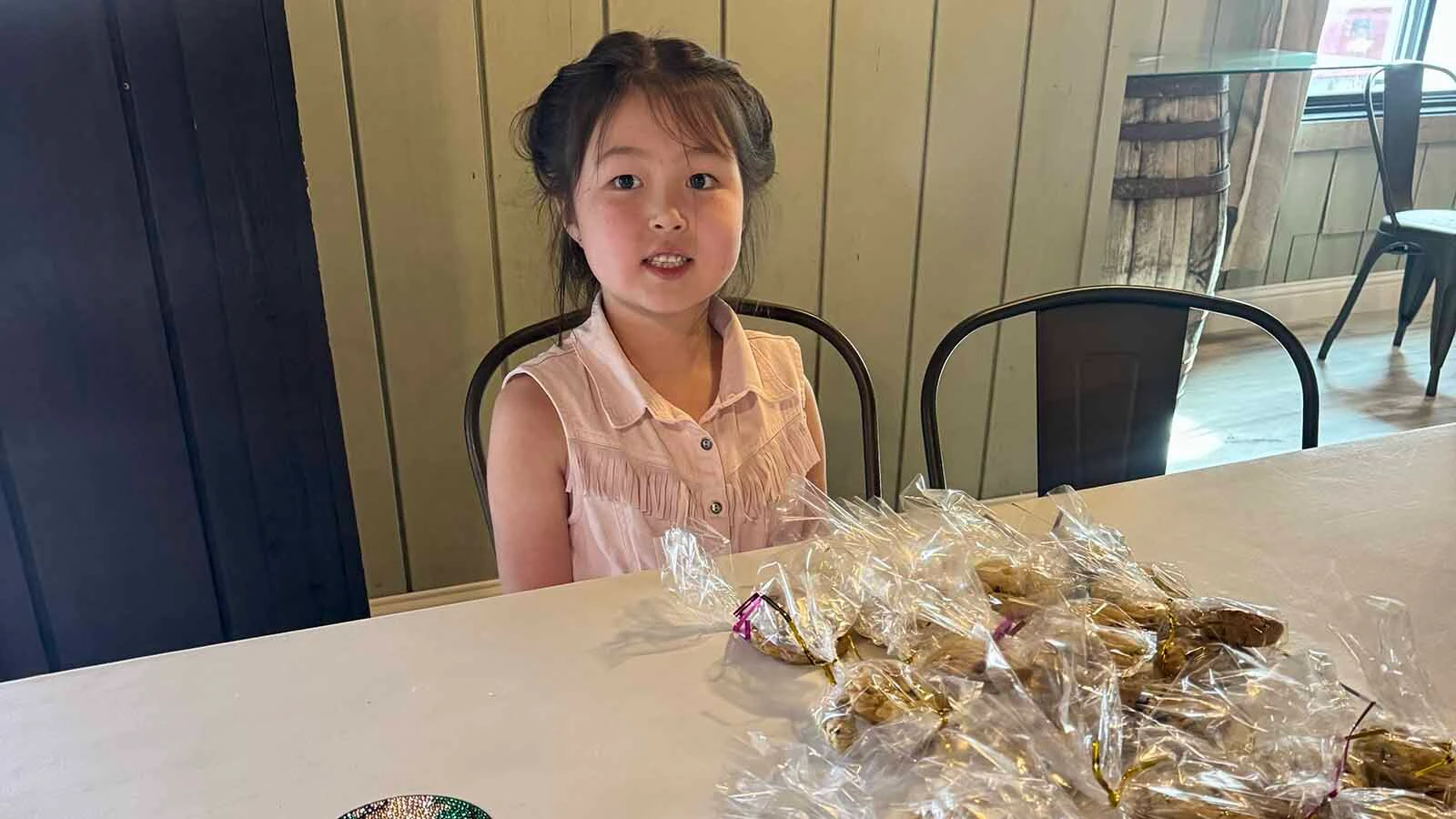 Homestead Learning student Marceline Aihara markets her handmade diamond art coasters and chocolate chip cookies.