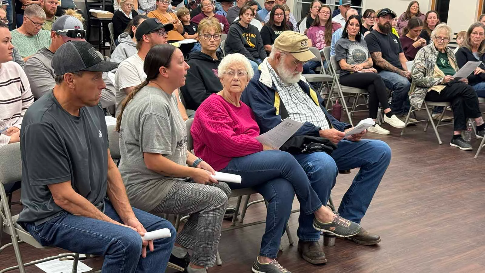 More than 100 people packed into the Midwest Recreation Center on Wednesday to begin a full-court press to save grades 6-12 of their school from the chopping block.